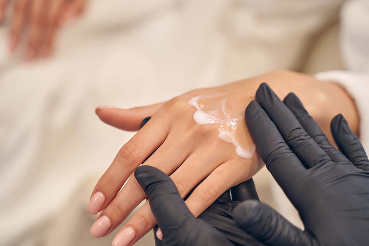 Hand cream being applied during a skincare treatment