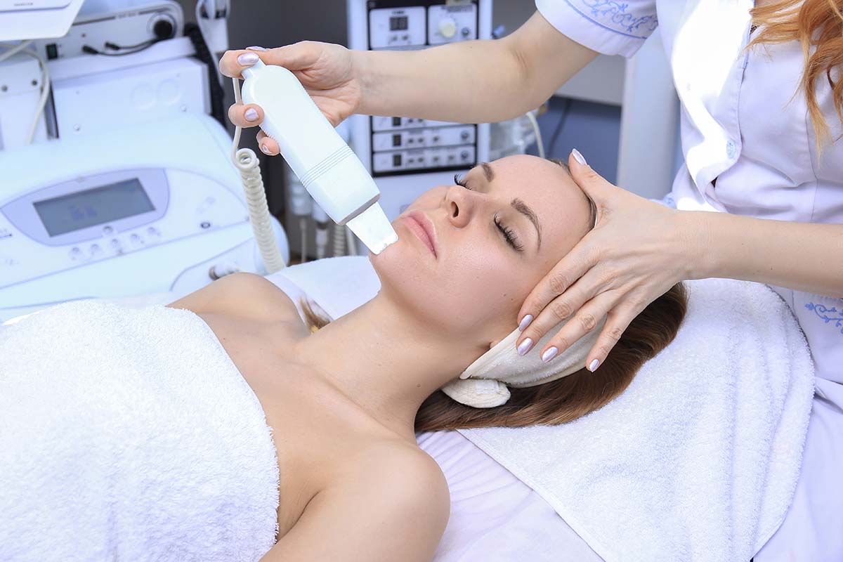 Woman receiving an ultrasonic facial treatment
