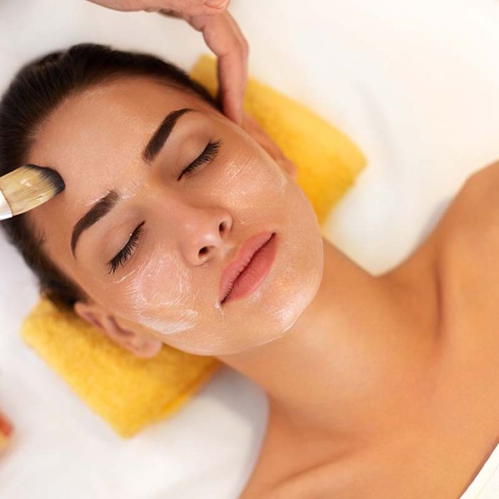 Woman receiving a dermaplaning facial treatment